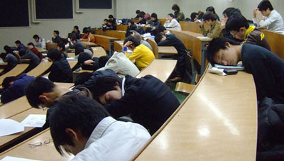 Picture of students sleeping in a lecture hall